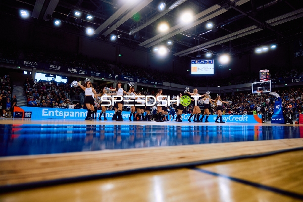 Cheerleader-Gruppe tanzt auf dem Basketballfeld.