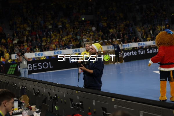 Moderator spricht mit einem Mikrofon zu den Zuschauern.