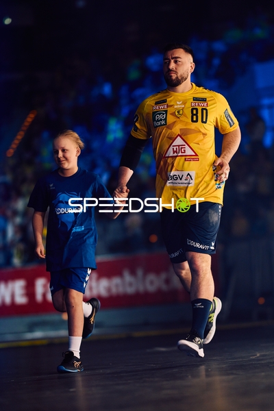 Spieler und Kind laufen ein