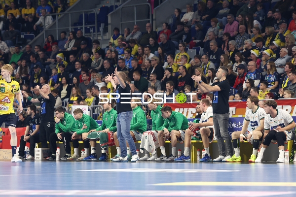 Teams beobachten das Spiel von der Seitenlinie