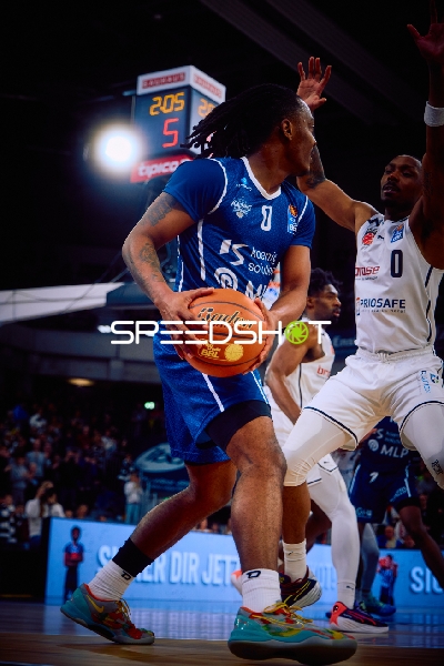 Ein Spieler von MLP Academics Heidelberg hält den Basketball und versucht, den Gegner zu umgehen.