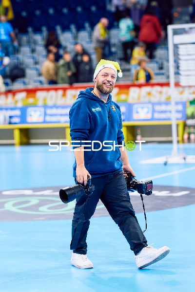 Ein Fotograf geht über das Spielfeld.