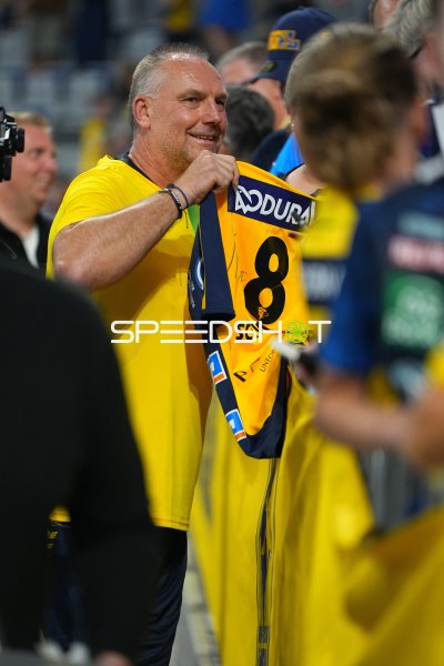 Christian Schwarzer hält sein signiertes Trikot #8 in der SAP Arena
