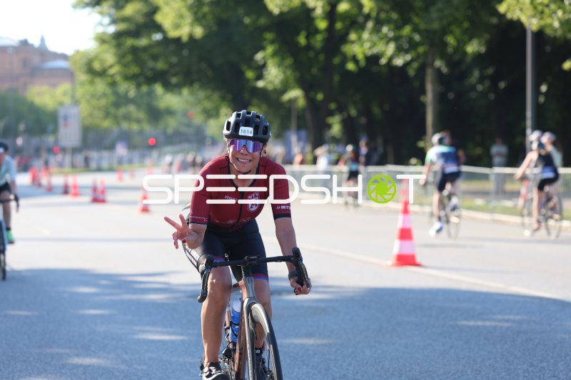 Triathletin (#1614) zeigt Victory-Zeichen auf der Radstrecke in Hamburg