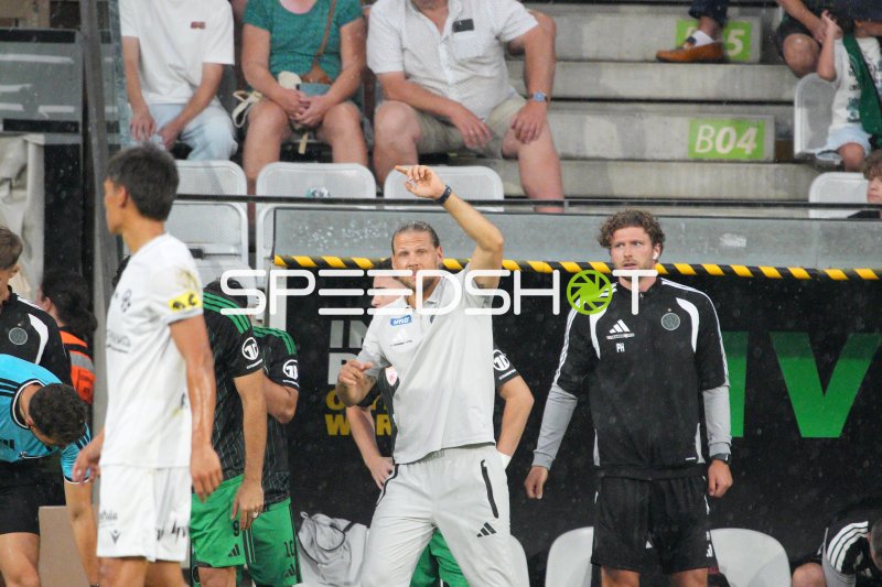 Trainer an der Seitenlinie gibt taktische Anweisungen beim Spiel im Tivoli
