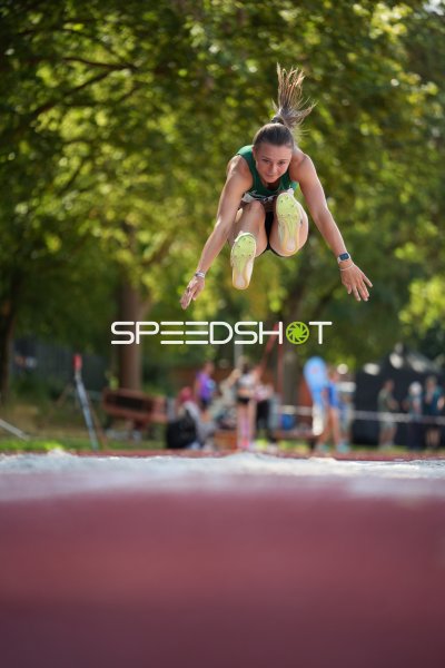 Weitsprung-Athletin im Flug über der Sandgrube in Hannover