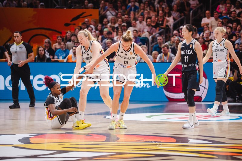 Leonie Fiebich (#13; Deutschland) hilft Teamkollegin vom Boden auf
