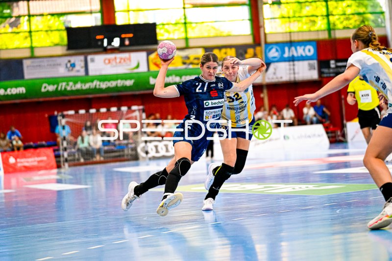 Zweikampf zwischen Rückraumspielerin (#27) und Abwehrspielerin (#32) im Sprungwurf
