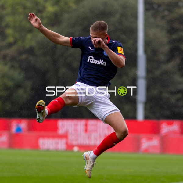 #19 Phil Harres (Holstein Kiel) bei Sprungaktion im Regen