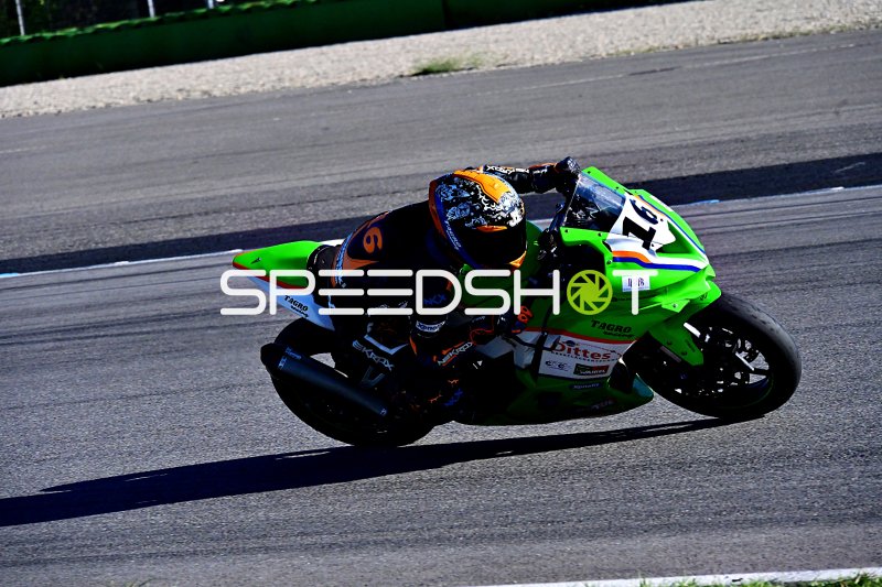 Motorradfahrer #19 auf grüner Kawasaki in Schräglage auf Hockenheim