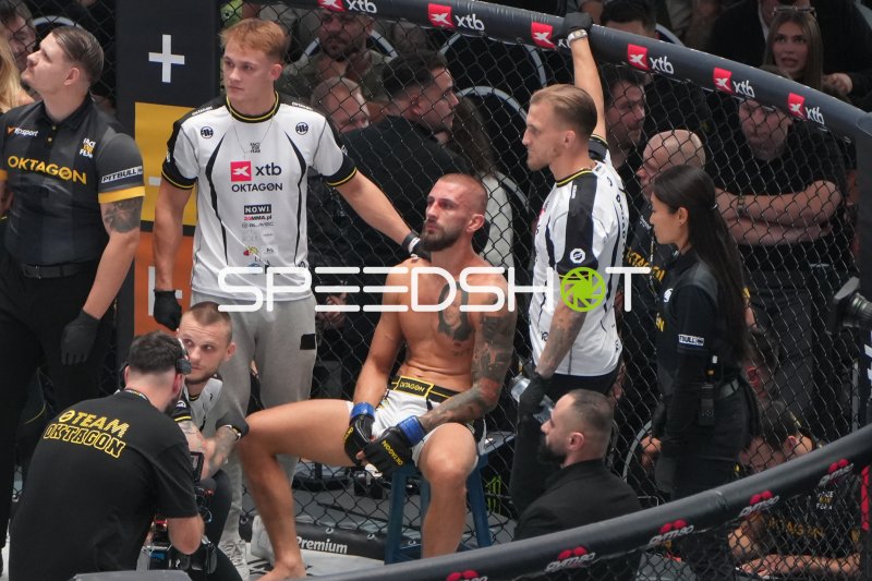 MMA-Kämpfer nach Kampf im Octagon mit Betreuungsteam