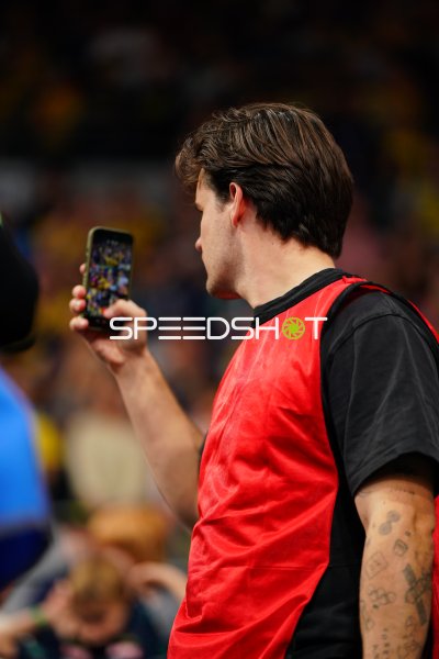 Mann mit rotem Leibchen filmt mit Smartphone in der SAP Arena