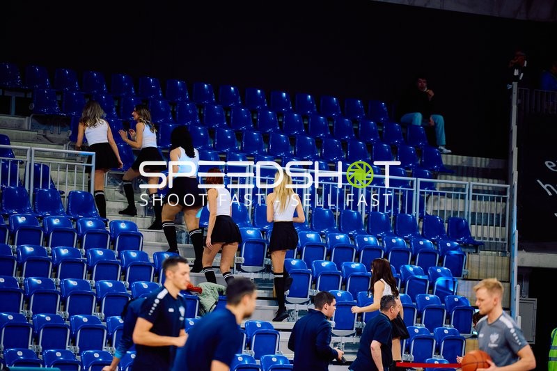 Zuschauer oder Eventpersonal bewegt sich durch die leeren Tribünen.