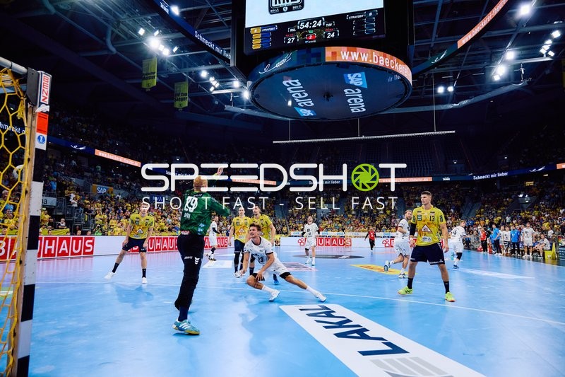 Ein Spieler der Rhein Neckar Löwen im grünen Trikot versucht, einen Wurf zu parieren.