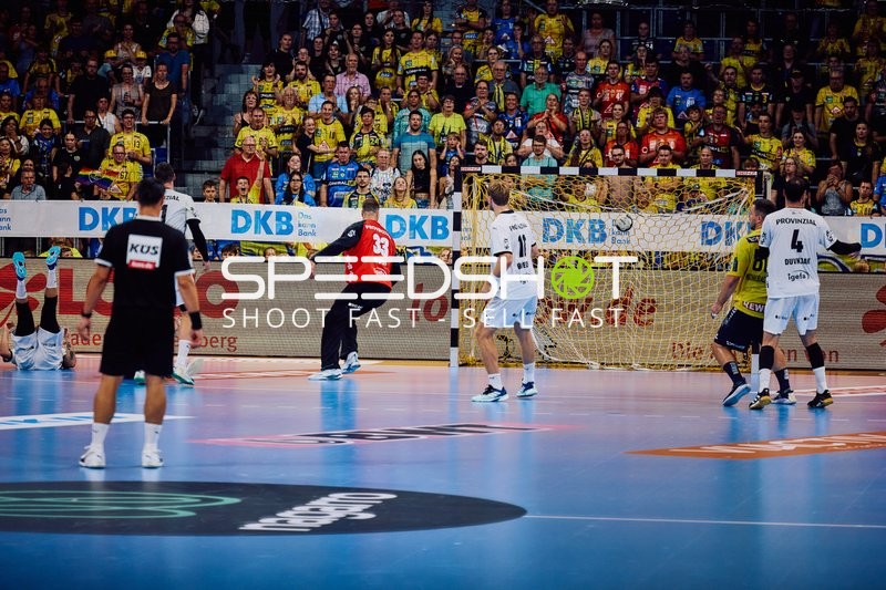 Ein Torwart versucht einen Torwurf zu verhindern.