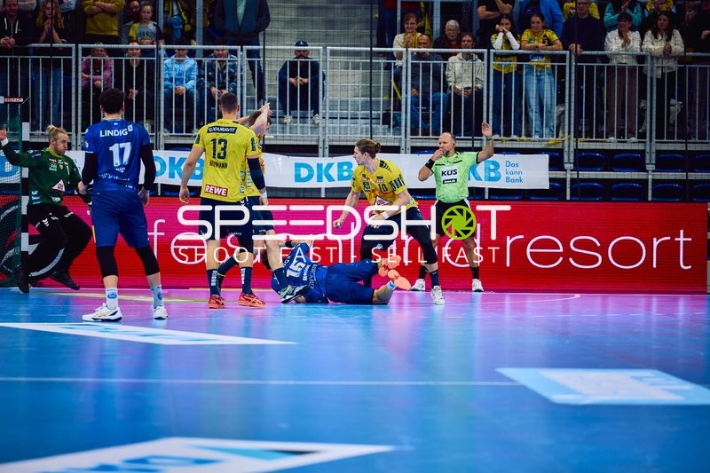 Ein Spieler von ThSV Eisenach liegt am Boden, umgeben von Spielern der Rhein Neckar Löwen.