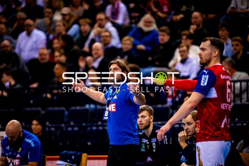 Coach and players observing or discussing during the match.