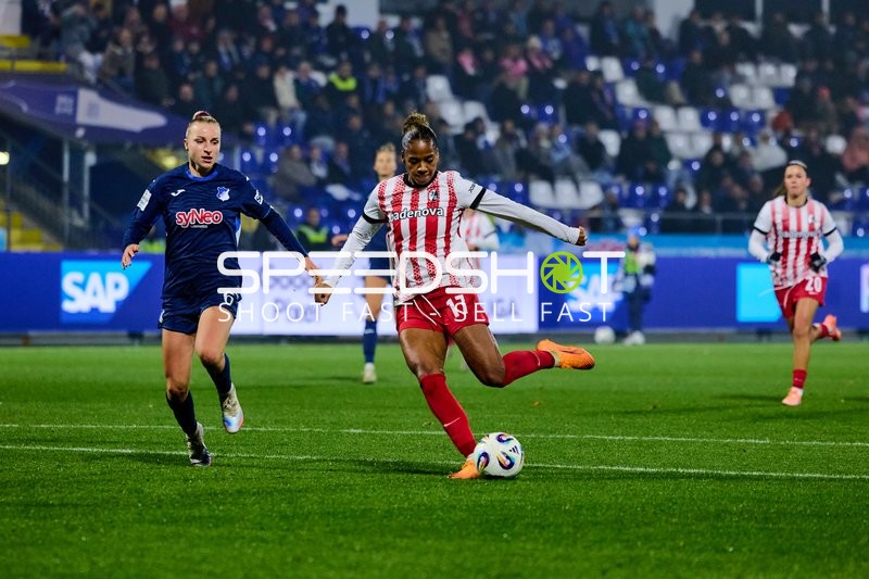 Spieler mit Ball und Verteidigerin