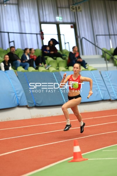 Athletin mit Staffelstab in Aktion