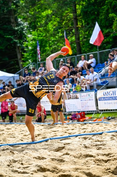 Spieler #23 beim Wurfversuch im Beach-Handball-Turnier