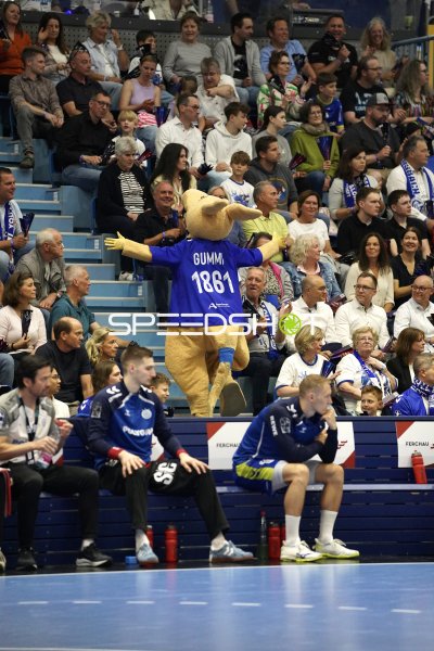 Maskottchen Gummi feiert vor der Trainerbank des VfL Gummersbach