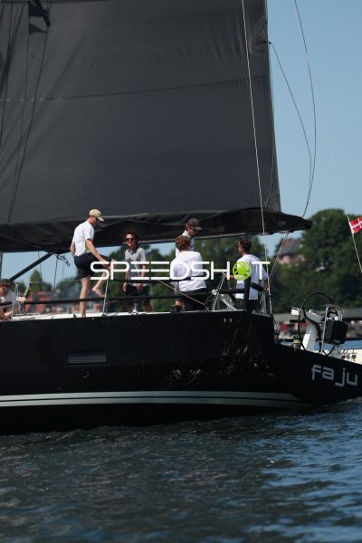 Crew an Bord einer schwarzen Rennyacht beim Segeln in Eckernförde